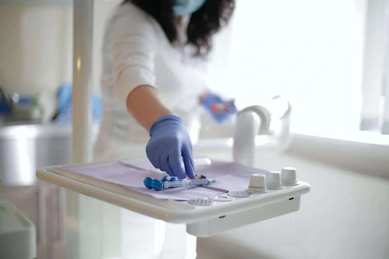 Nurse placing dental instruments